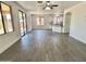 Open living room with ceramic tile flooring, large windows, and sliding glass doors to the backyard at 7116 W Sophie Ln, Laveen, AZ 85339