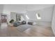 Cozy upstairs bonus room with skylights, plush seating, and neutral decor at 733 W El Camino Dr, Phoenix, AZ 85021