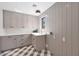 Well-organized laundry room with custom cabinets, modern fixtures, and stylish patterned floor at 733 W El Camino Dr, Phoenix, AZ 85021