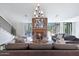 Bright living room featuring a striking brick fireplace, modern chandelier, and stylish furniture at 733 W El Camino Dr, Phoenix, AZ 85021