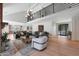 Open-concept living space with a modern fireplace, stylish seating, and a view to the entryway at 733 W El Camino Dr, Phoenix, AZ 85021