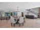 Bright, open living space with a dining table and modern staircase with steel railing at 733 W El Camino Dr, Phoenix, AZ 85021