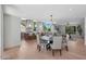 Bright, open living space featuring a dining table, kitchen with bar seating, and large windows at 733 W El Camino Dr, Phoenix, AZ 85021