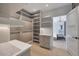 Spacious walk-in closet with custom shelving and drawers, flowing into an ensuite bathroom at 733 W El Camino Dr, Phoenix, AZ 85021