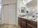 Bathroom featuring double sinks, vanity with dark cabinets, and tiled floor at 7419 S 25Th Dr, Phoenix, AZ 85041