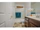Clean bathroom with a shower-tub combo, framed mirror, and wood vanity at 7419 S 25Th Dr, Phoenix, AZ 85041