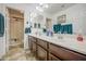 Bathroom featuring double sinks with white countertops, and a glass-enclosed shower at 7419 S 25Th Dr, Phoenix, AZ 85041