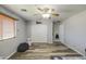 This bedroom has light gray walls, light-colored wood floors, and a ceiling fan at 7419 S 25Th Dr, Phoenix, AZ 85041