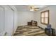 A spare bedroom has light walls, wood floors, and shutters on the windows at 7419 S 25Th Dr, Phoenix, AZ 85041