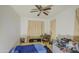 Bedroom with ceiling fan, curtains, keyboard with chair and carpeted floor at 7419 S 25Th Dr, Phoenix, AZ 85041