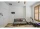 Spare bedroom featuring a futon with wood-like flooring, a ceiling fan, and natural light at 7419 S 25Th Dr, Phoenix, AZ 85041