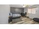 This bedroom features a desk, shelves, ceiling fan, and a grey accent wall at 7419 S 25Th Dr, Phoenix, AZ 85041