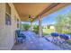 Covered patio with stone floors offers an outdoor living space overlooking the landscaped backyard at 7419 S 25Th Dr, Phoenix, AZ 85041