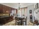 Dining area featuring brown cabinets and a stylish light fixture at 7419 S 25Th Dr, Phoenix, AZ 85041