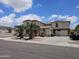 Expansive two-story home with lush landscaping, a long driveway, and a two-car garage at 7419 S 25Th Dr, Phoenix, AZ 85041