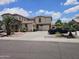 Expansive two-story home with lush landscaping, a long driveway, and a two-car garage at 7419 S 25Th Dr, Phoenix, AZ 85041