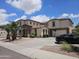 Expansive two-story home with lush landscaping, a long driveway, and a two-car garage at 7419 S 25Th Dr, Phoenix, AZ 85041