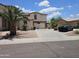 Charming two-story home featuring a basketball hoop over the garage and well manicured landscaping at 7419 S 25Th Dr, Phoenix, AZ 85041