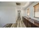 Bright hallway with wood-look floors, neutral walls, and a built-in storage buffet at 7419 S 25Th Dr, Phoenix, AZ 85041