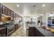 Spacious kitchen boasts granite counters, stainless appliances and mosaic tile backsplash at 7419 S 25Th Dr, Phoenix, AZ 85041