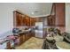 Kitchen featuring stainless steel appliances, dark cabinetry, and tile flooring at 7419 S 25Th Dr, Phoenix, AZ 85041