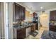 View of kitchen area with brown cabinets and stainless steel appliances at 7419 S 25Th Dr, Phoenix, AZ 85041