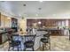 Spacious kitchen with dark cabinetry, mosaic backsplash, granite countertops, and breakfast bar at 7419 S 25Th Dr, Phoenix, AZ 85041