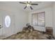 Bright living room features tile flooring, ceiling fan, and natural light from the window at 7419 S 25Th Dr, Phoenix, AZ 85041
