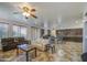 Open-concept living room with neutral tones, tile flooring, ceiling fan, and furniture at 7419 S 25Th Dr, Phoenix, AZ 85041