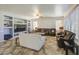 This living room has couches, built-in shelving, a ceiling fan, and many windows at 7419 S 25Th Dr, Phoenix, AZ 85041