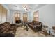 Cozy living room with plush sofas, wooden shutters, and a ceiling fan at 7419 S 25Th Dr, Phoenix, AZ 85041