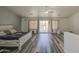 Open main bedroom with wood floors, a ceiling fan, and lots of natural light at 7419 S 25Th Dr, Phoenix, AZ 85041