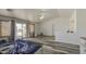 Spacious main bedroom with wood-look floors, a ceiling fan, and a private balcony at 7419 S 25Th Dr, Phoenix, AZ 85041