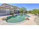 Backyard features a custom pool with rock accents, lush landscaping, and a fenced perimeter at 7419 S 25Th Dr, Phoenix, AZ 85041