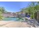 Sparkling pool with stone features nestled within a private backyard oasis at 7419 S 25Th Dr, Phoenix, AZ 85041
