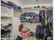 Walk-in closet features built-in shelves and hanging racks for optimal storage and organization solutions at 7419 S 25Th Dr, Phoenix, AZ 85041