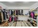 Spacious walk-in closet provides ample storage with hanging racks and shelving for organization at 7419 S 25Th Dr, Phoenix, AZ 85041