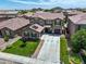 Two-story home with a well-manicured lawn, three-car garage, and solar panels in a quiet residential neighborhood at 761 W Desert Hollow Dr, San Tan Valley, AZ 85143