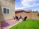 Cozy backyard featuring a fire pit, comfortable seating, and easy-to-maintain synthetic grass at 761 W Desert Hollow Dr, San Tan Valley, AZ 85143