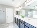 Bright bathroom with double sink vanity and large mirror with decorative lighting at 761 W Desert Hollow Dr, San Tan Valley, AZ 85143