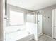 Bright bathroom with a large tub with jets and glass-enclosed shower with built in bench at 761 W Desert Hollow Dr, San Tan Valley, AZ 85143