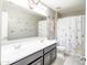 A cute bathroom featuring a double sink vanity and butterfly-themed decor at 761 W Desert Hollow Dr, San Tan Valley, AZ 85143