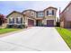 Charming two-story home featuring a three-car garage and pristine front lawn with tasteful landscaping at 761 W Desert Hollow Dr, San Tan Valley, AZ 85143