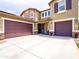 Stunning two-story home with a three-car garage, manicured landscaping, and a welcoming entryway at 761 W Desert Hollow Dr, San Tan Valley, AZ 85143