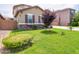 Well-kept lawn with a decorative tree and tasteful landscaping in front of a charming home at 761 W Desert Hollow Dr, San Tan Valley, AZ 85143