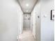 A well-lit hallway with neutral paint and multiple doorways for easy access to rooms at 761 W Desert Hollow Dr, San Tan Valley, AZ 85143