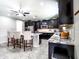 Open concept kitchen with dark cabinets, stainless appliances, a granite island, and counter seating at 761 W Desert Hollow Dr, San Tan Valley, AZ 85143