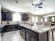 Gourmet kitchen boasts granite counters, dark cabinets, stainless appliances, and views to an adjacent dining area at 761 W Desert Hollow Dr, San Tan Valley, AZ 85143
