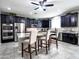Spacious kitchen with dark cabinets, stainless steel appliances, granite countertops, and an island with seating at 761 W Desert Hollow Dr, San Tan Valley, AZ 85143