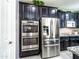 Modern kitchen features stainless steel appliances, granite countertops, and stylish dark-stained cabinetry at 761 W Desert Hollow Dr, San Tan Valley, AZ 85143
